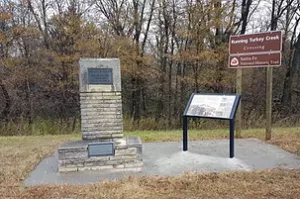 a plaque a sign and a monument