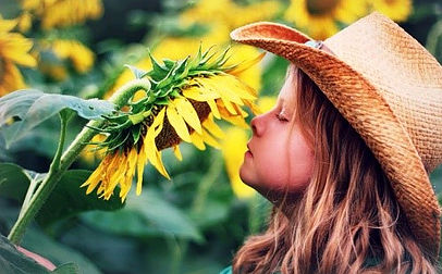 Girl smelling a flower