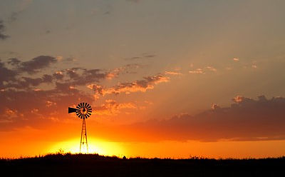 horizon of a sunset and an old-style farm-windmill