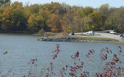 shoreline with parking lot in a wooded area